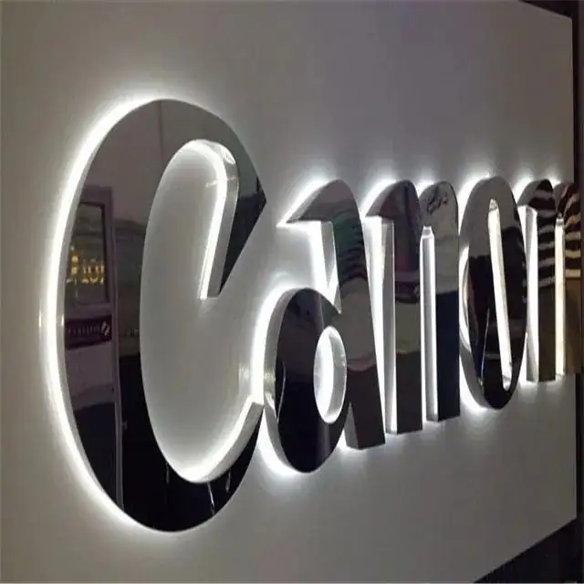 Reverse-lit halo letters glowing against a wall