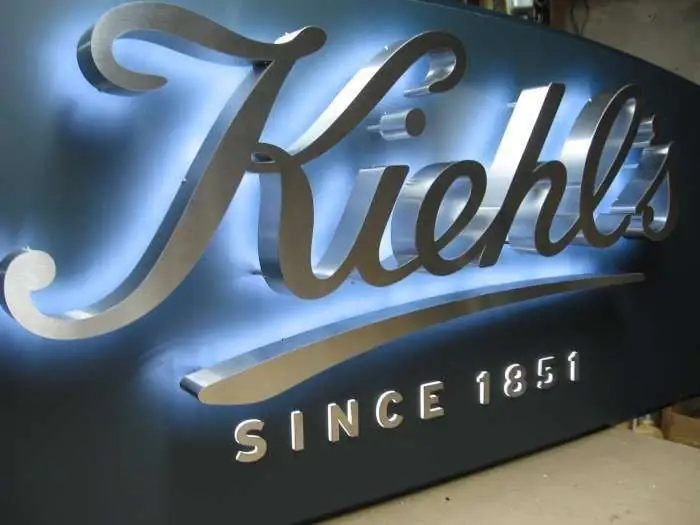 Backlit stainless steel script letters on a fabricated panel