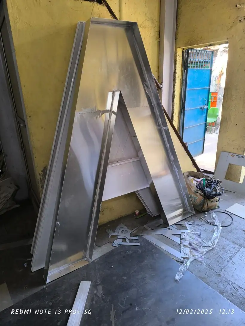 Tall stainless steel letter A under fabrication in the workshop